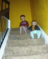 Alex and Hannah watch the Slinky amble down the stairs