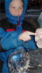 Michael with his finger in the nose of the ice sculpture